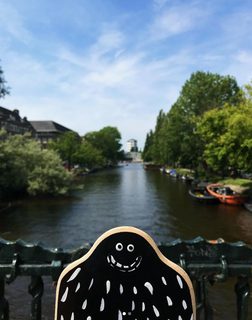 A Lyle held up in front of Amsterdam