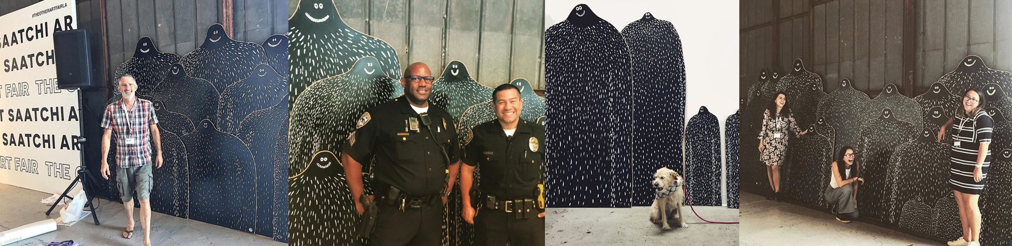 Four photographs from an art fair: a man walking past a row of tall Lyle boards, two police officers posing between them, a dog sitting in front of a herd, and three women leaning into the herd.