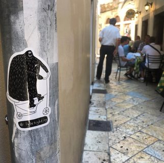 A Lyle held up in front of Corfu