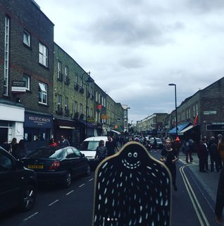A Lyle held up in front of Broadway Market