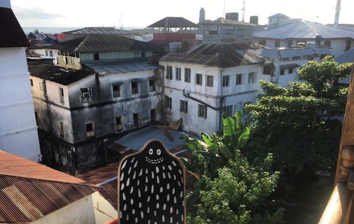 A Lyle held up in front of Stone Town