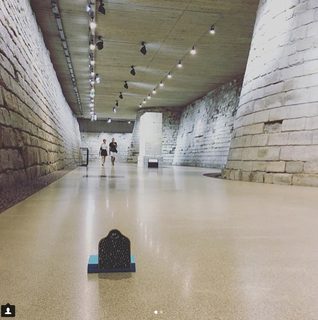 A Lyle held up in front of Louvre Museum