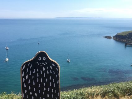 A Lyle held up in front of Lundy Island
